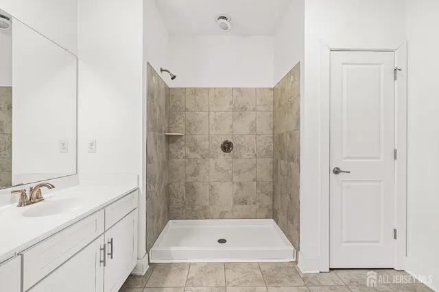 a bathroom with a double vanity sink mirror double and shower
