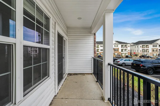 front view of a brick house with a yard