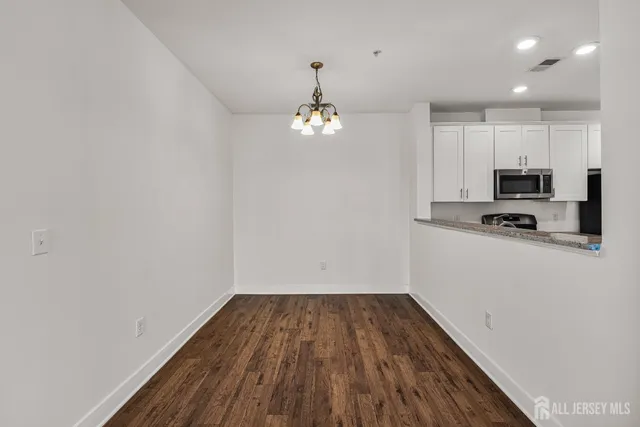 a view of a kitchen with wooden floor and a sink