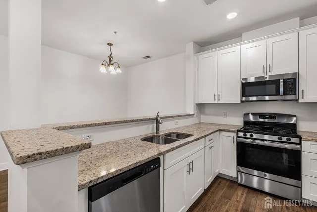 a kitchen that has a sink and a stove