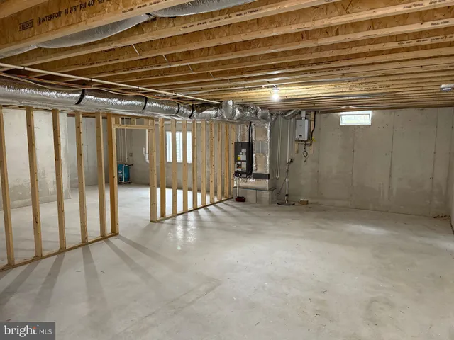a view of water heater room with stairs