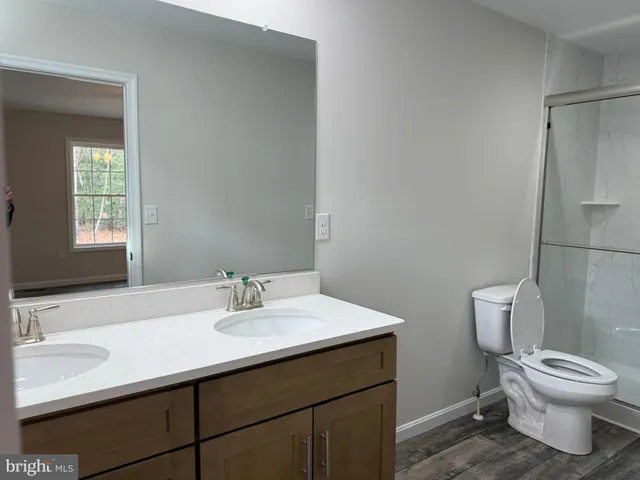 a bathroom with a glass shower door