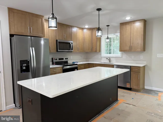 a view of a kitchen with furniture and chandelier