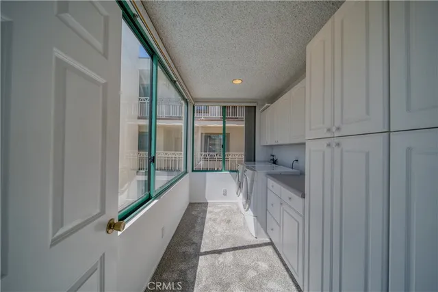 a view of a kitchen with kitchen island granite countertop a refrigerator oven a sink and a dishwasher