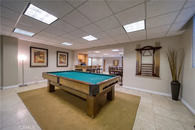 a room with pool table and windows