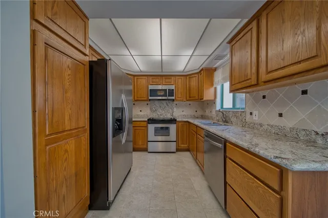 a kitchen with stainless steel appliances granite countertop a sink and cabinets