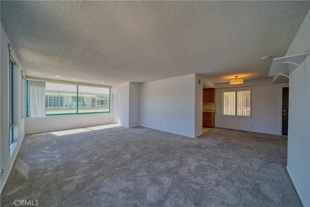 an empty room with windows and closet