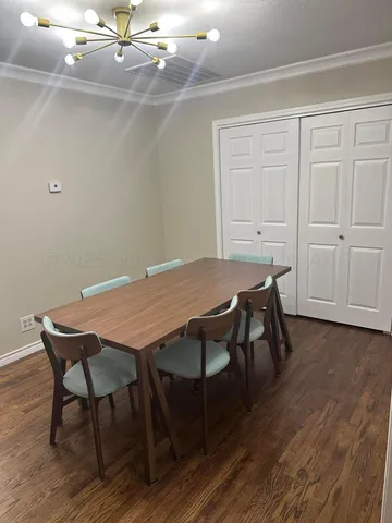 a view of a workspace with furniture and wooden floor