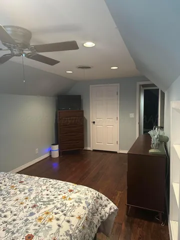 a bedroom with a bed and a dresser