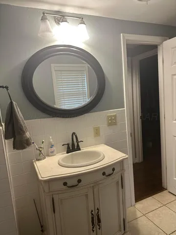a bathroom with a toilet a sink and a window