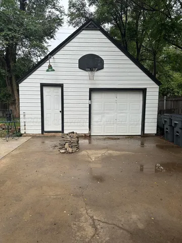 a backyard of a house with table and chairs
