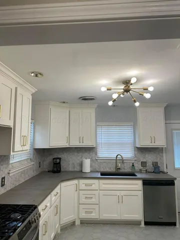 a kitchen with a sink cabinets and window