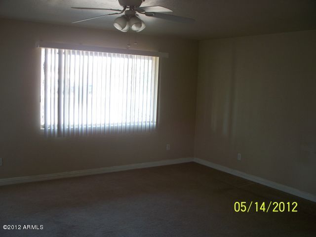 4837 West Osborn Road Phoenix, AZ 85031 - Photo 6 of 14 an empty room with a window