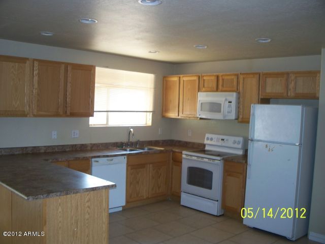 4837 West Osborn Road Phoenix, AZ 85031 - Photo 8 of 14 a kitchen with a sink stove and refrigerator