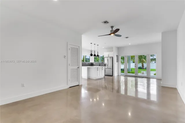 a view of a living room hardwood floor and a ceiling fan