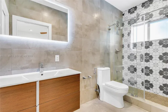 a bathroom with a sink toilet and shower