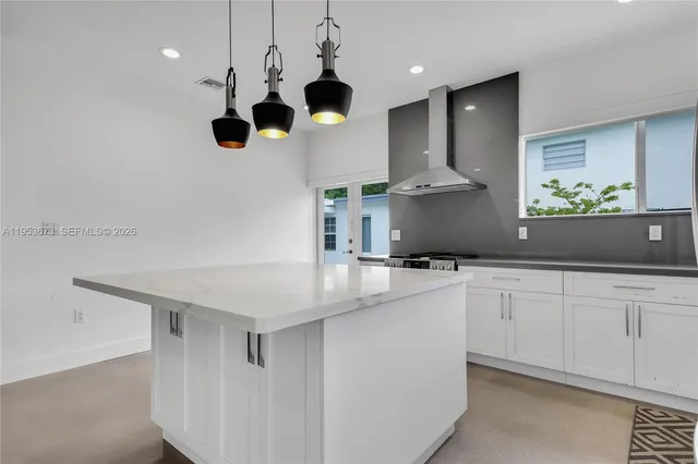 a kitchen with stainless steel appliances a white stove top oven and cabinets