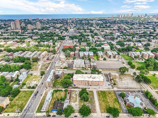 an aerial view of residential houses with city view