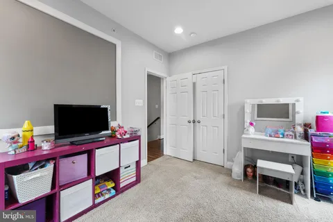 a living room with furniture and flat screen tv