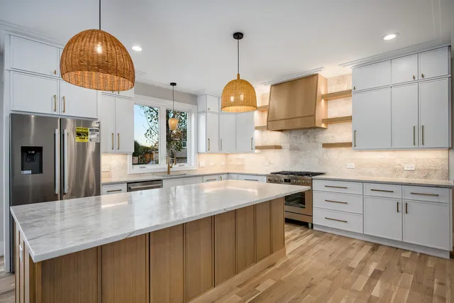 a kitchen with cabinets and a chandelier