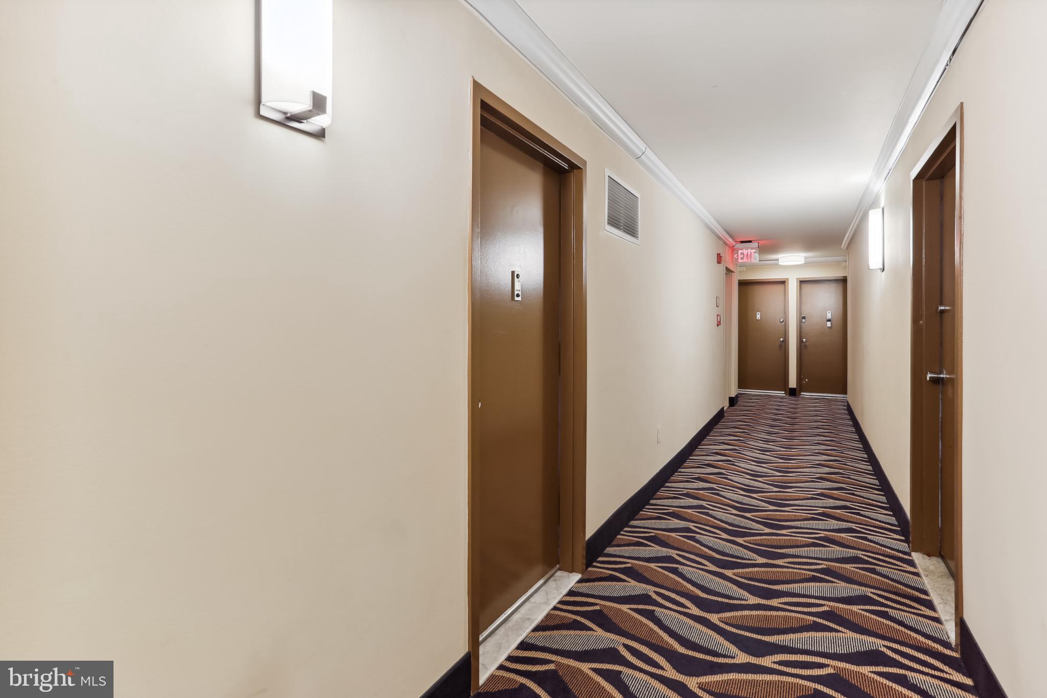 1111 University Boulevard West, Unit 1003 Silver Spring, MD 20902 - Photo 11 of 38 a view of a hallway with wooden floor