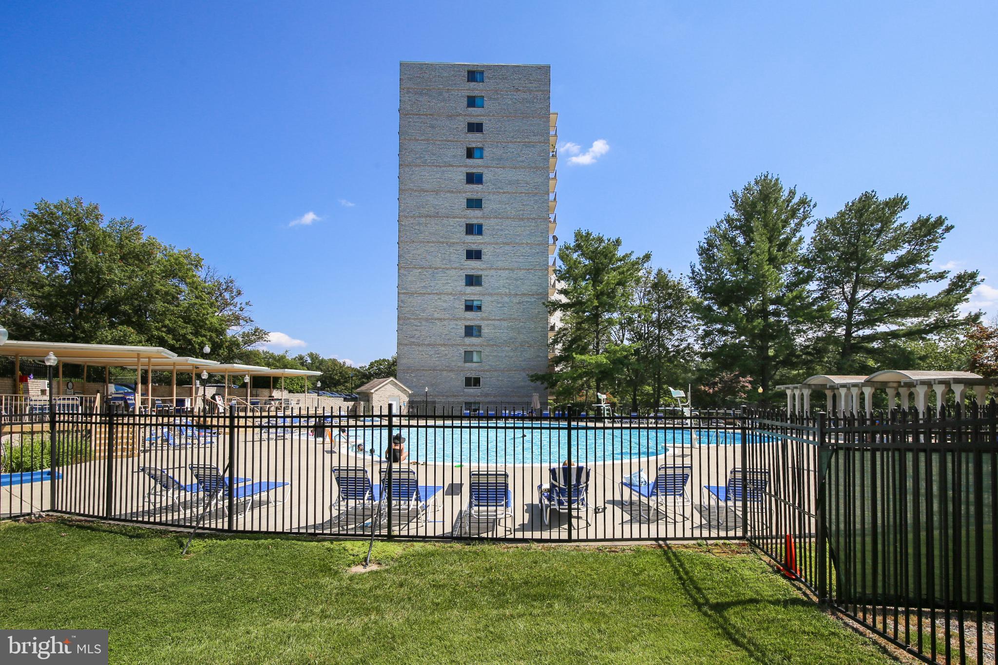 1111 University Boulevard West, Unit 1003 Silver Spring, MD 20902 - Photo 31 of 38 a view of a deck with a big yard and large trees
