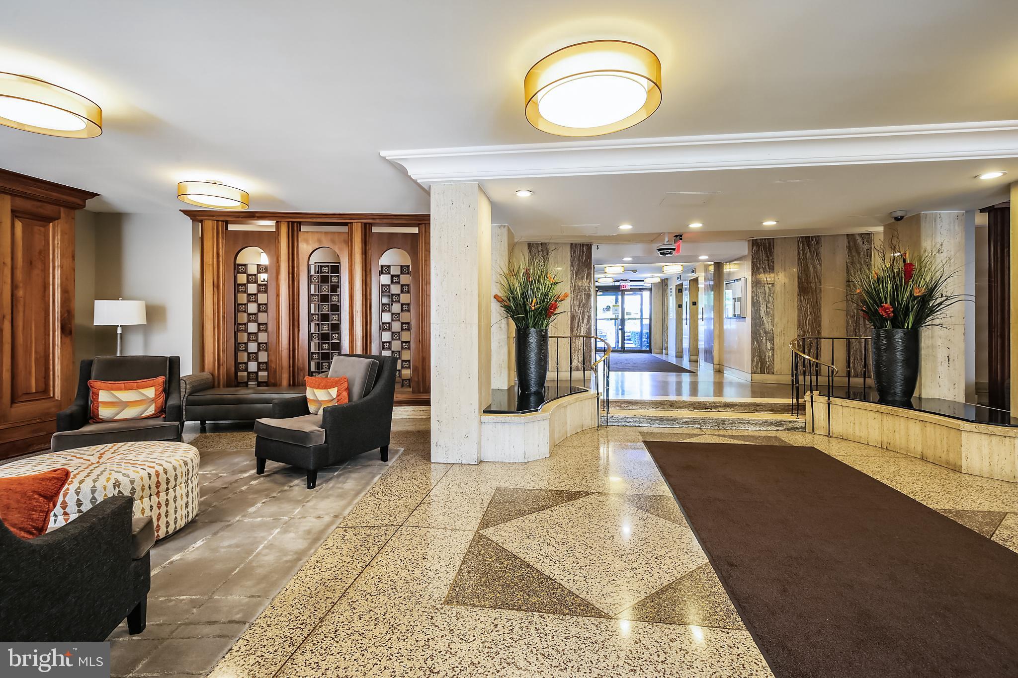 1111 University Boulevard West, Unit 1003 Silver Spring, MD 20902 - Photo 6 of 38 a living room with furniture and large windows