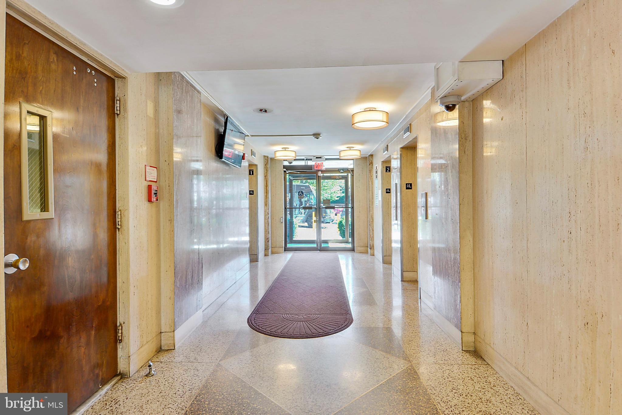 1111 University Boulevard West, Unit 1003 Silver Spring, MD 20902 - Photo 8 of 38 a bathroom with a glass shower door and a glass door