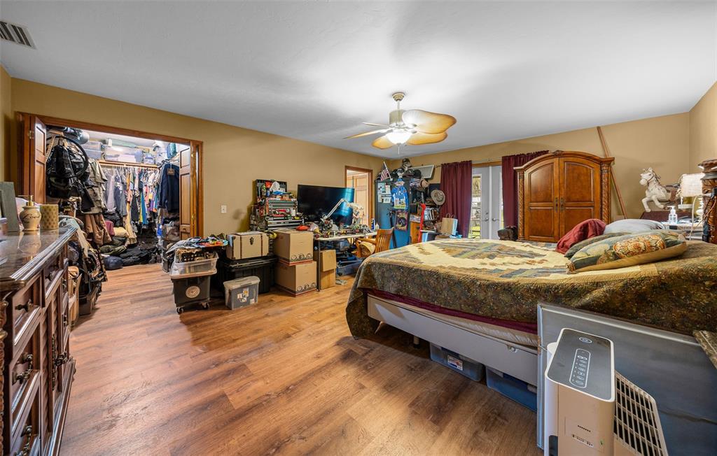 732 Carl Wilson Road Fort White, FL 32038 - Photo 19 of 80 a bed room with a bed and a chandelier