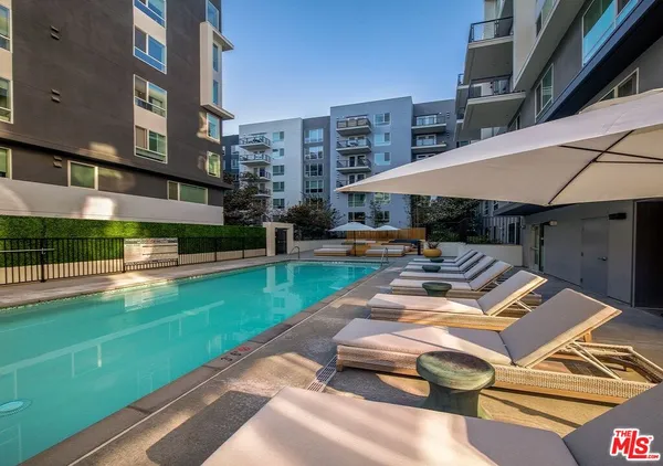 a roof deck with table and chairs