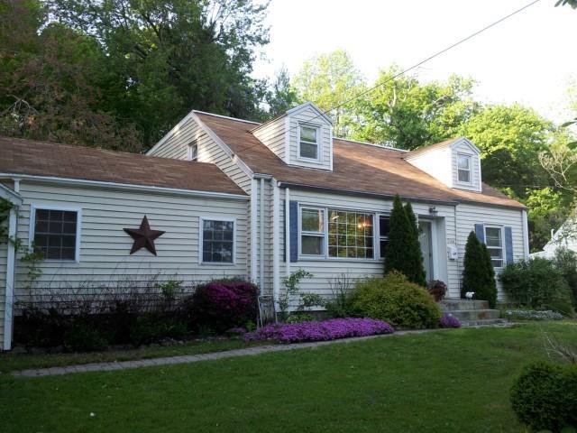a front view of a house with a garden