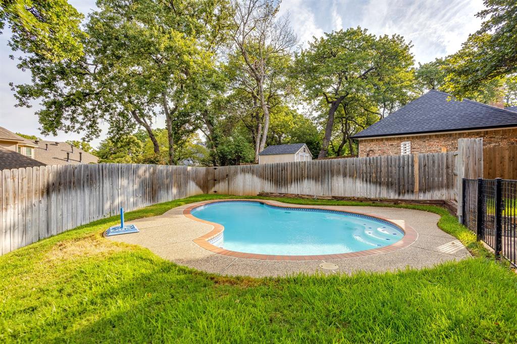 3068 High Ridge Drive Grapevine, TX 76051 - Photo 38 of 40 Curved in-ground swimming pool with an exposed aggregate surround and brick coping
