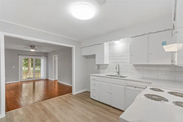 a kitchen with a sink cabinets and window