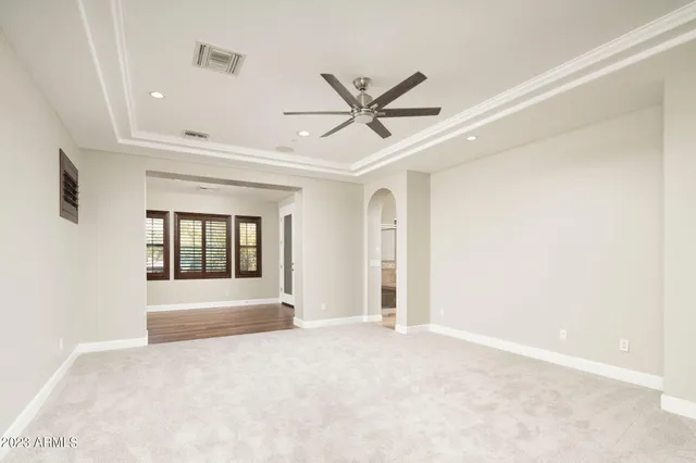 a view of a livingroom with a ceiling fan and window