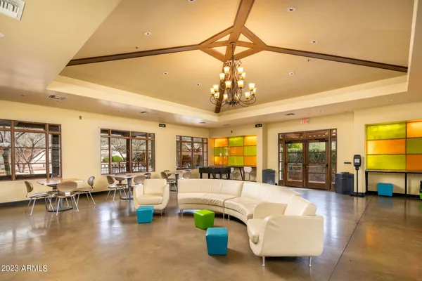 a living room with fireplace furniture and a chandelier