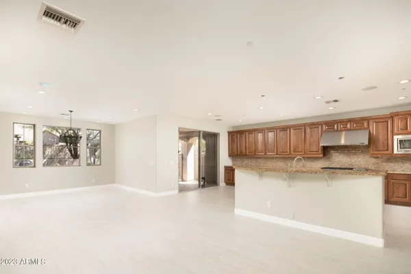a kitchen with stainless steel appliances granite countertop a refrigerator sink and stove