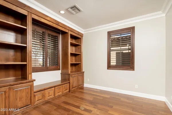 a view of kitchen with wooden floor and cabinets