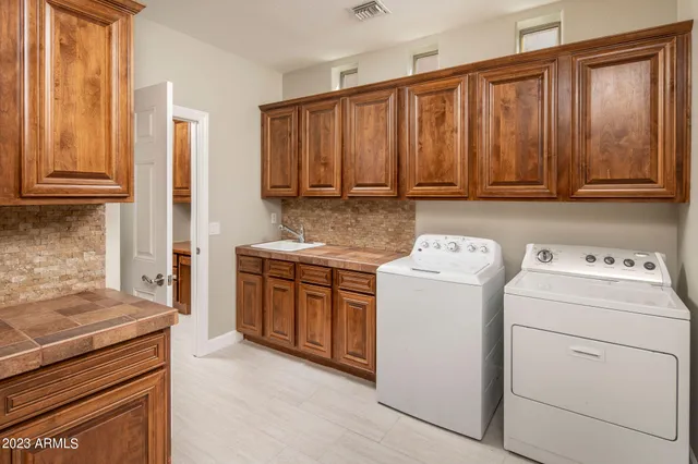 a kitchen with wooden cabinets and a stove top oven