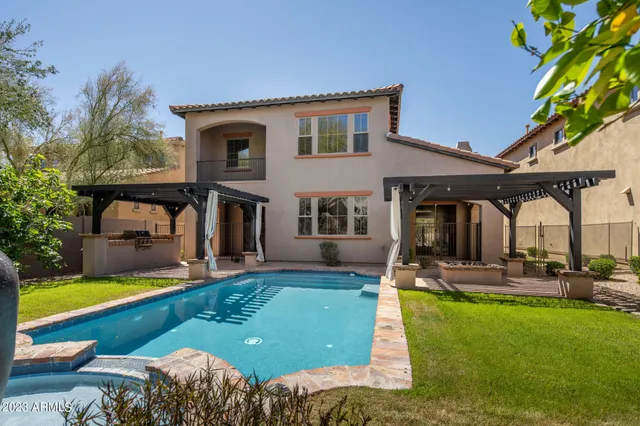 a front view of a house with swimming pool yard and patio