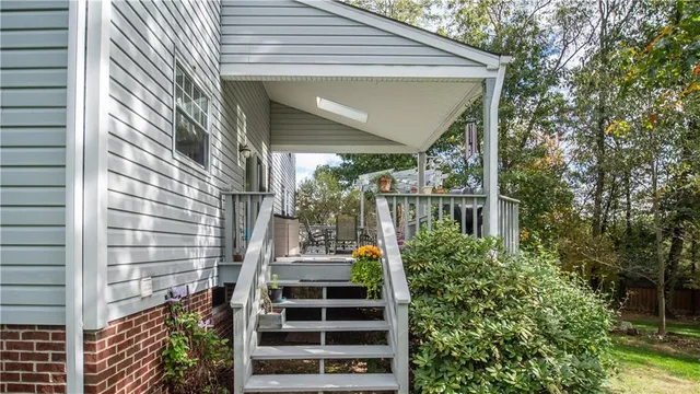 a balcony with table and chairs