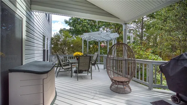 a view of balcony with wooden floor and outdoor seating