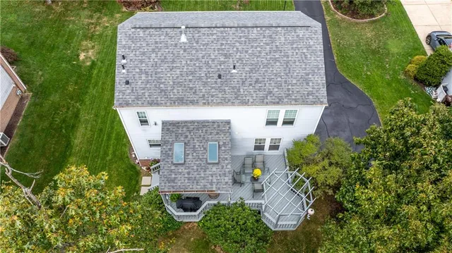 an aerial view of a house with garden space and street view
