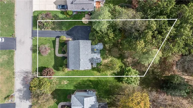 an aerial view of a houses with a yard