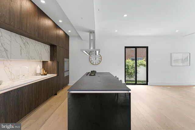 a view of a dining room with furniture and a potted plant