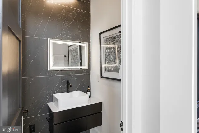 a bedroom with a large bed chandelier and a window