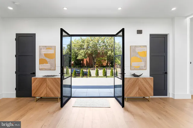 a living room with furniture and large windows
