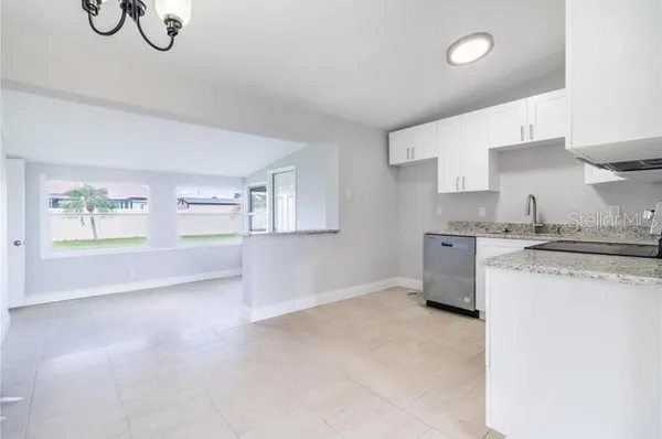 a kitchen with stainless steel appliances granite countertop a sink and a stove