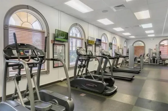 a room with gym equipment and a view of living room