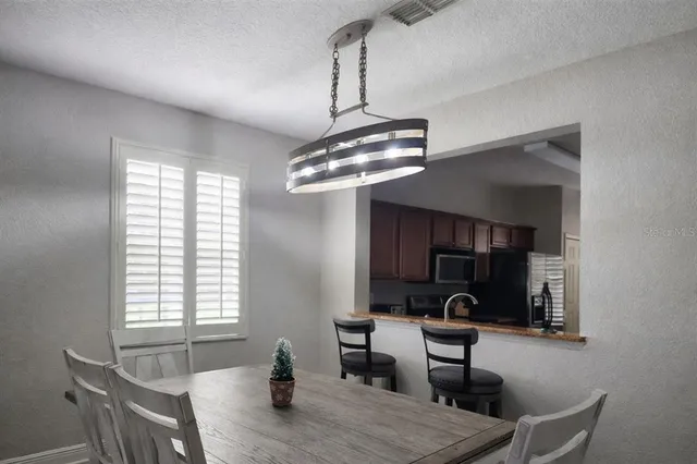 a kitchen with a table and chairs in it