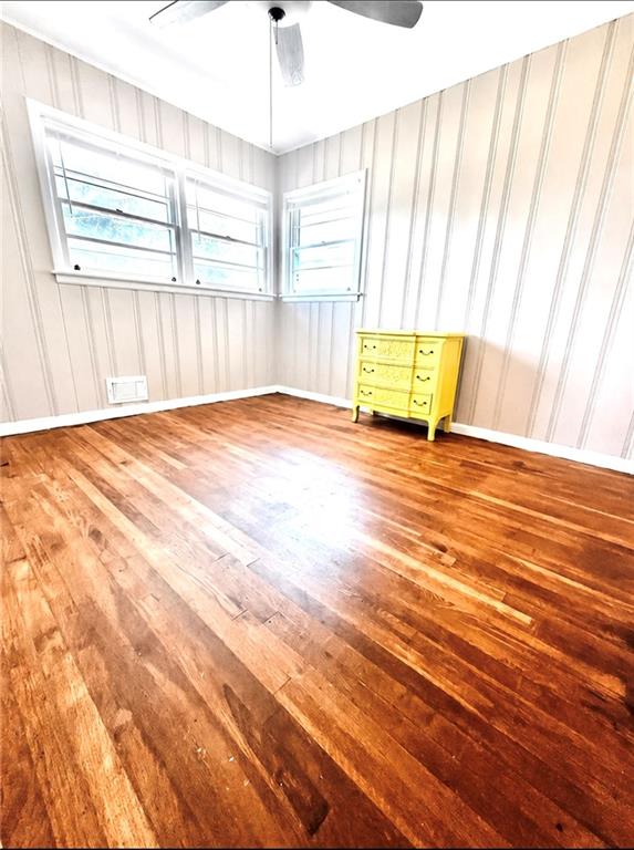 119 Fifth Avenue Jonesboro, GA 30236 - Photo 10 of 29 an empty room with wooden floor and windows